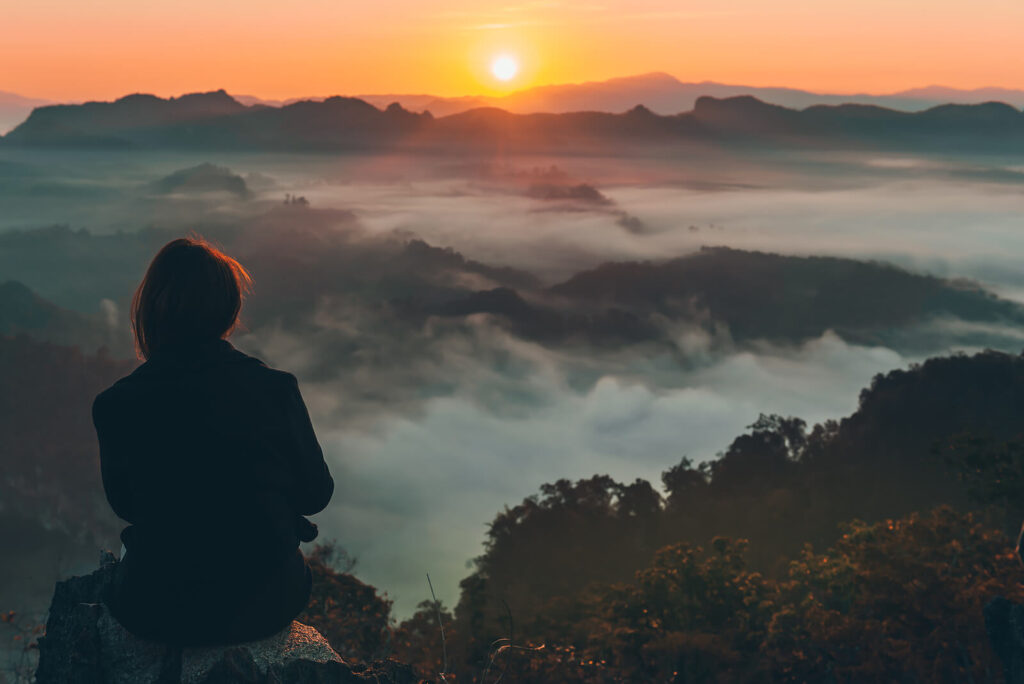 Woman sitting on an overlook contemplating things. Do you find that you haven't been able to slide back into your normal routine or you don't even remember what normal is? Therapy foor anxiety and depression in Virginia can he;lp you create a new better normal that works for you!