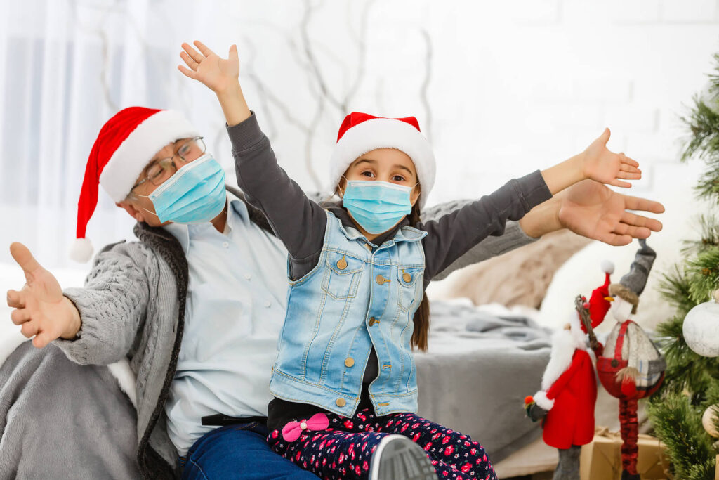 A grandparent and child smile behind masks while wearing santa hats. Learn how to address seasonal depression by searching for depression treatment in Richmond, VA. Search for a therapist for men in Powhatan, VA for help with depression treatment in Charlottesville VA and other services. 