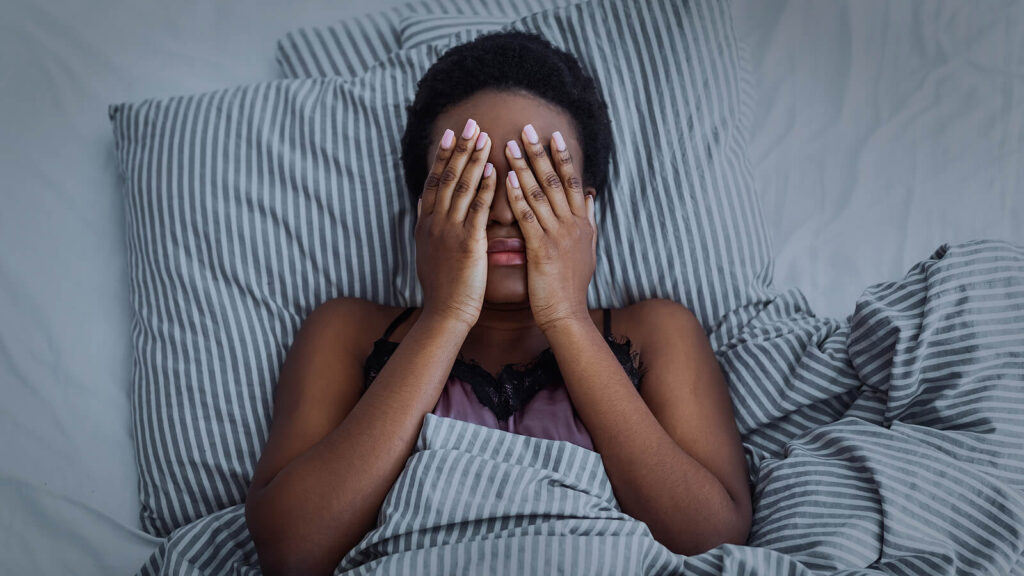 A woman covers her face while laying in bed. This could represent the effects of depression that depression treatment in Richmond, VA can help you overcome. Search for an equine therapist in Virginia for help during the holidays. Contact a therapist for men in Powhatan, VA today. 