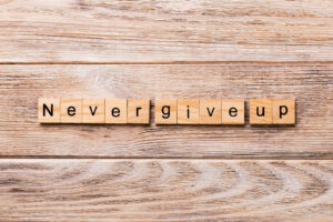 A close up of wooden blocks with letters that spell "never give up". Learn how EMDR therapy in Richmond, VA can offer support with coping techniques. Search for trauma therapy in Richmond, VA and how an online therapist in Powhatan, VA can help you today. 