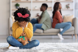 A child sits on the floor, crying as their parents argue in the background on the couch. This could represent some of the effects of narcissistic parents that a narcissism therapist in Richmond, VA can address. Learn more about narcissism therapy in Powhatan, VA and how a trauma therapist in Richmond, VA can help today. 