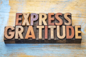 A close up wooden block letters that spell "express gratitude". Learn how a depression therapist in Powhatan, VA can help equip you with coping techniques this holiday season by searching for EMDR in Richmond, VA and other services like trauma therapy in Richmond today. 