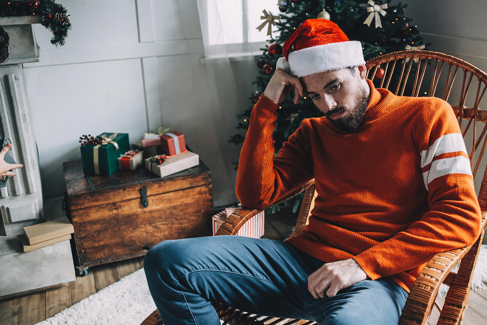 A man wearing a Santa hat sits alone in a chair with a sad expression. Learn how a depression therapist in Powhatan, VA can offer support with addressing isolation during the holiday season. Search for trauma therapy in Richmond, VA and how EMDR can offer support today.