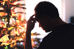 A silhouette of a man standing in front of a Christmas tree with a stressed expression. This could symbolize the stress of the holiday season. Learn more about depression treatment in Richmond, VA and how trauma therapy in Richmond, VA can offer support with overcoming past pain. Contact a depression therapist in Powhatan, VA to learn more. 