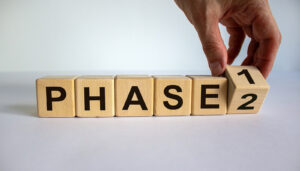 A close up of a hand moving a wooden block face with numbers in front of the word “phase”. This could represent the different phases of EMDR therapy in Richmond, VA that an EMDR therapist in Powhatan, VA can help offer. Search for EMDR intensives in Virginia and other services today. 