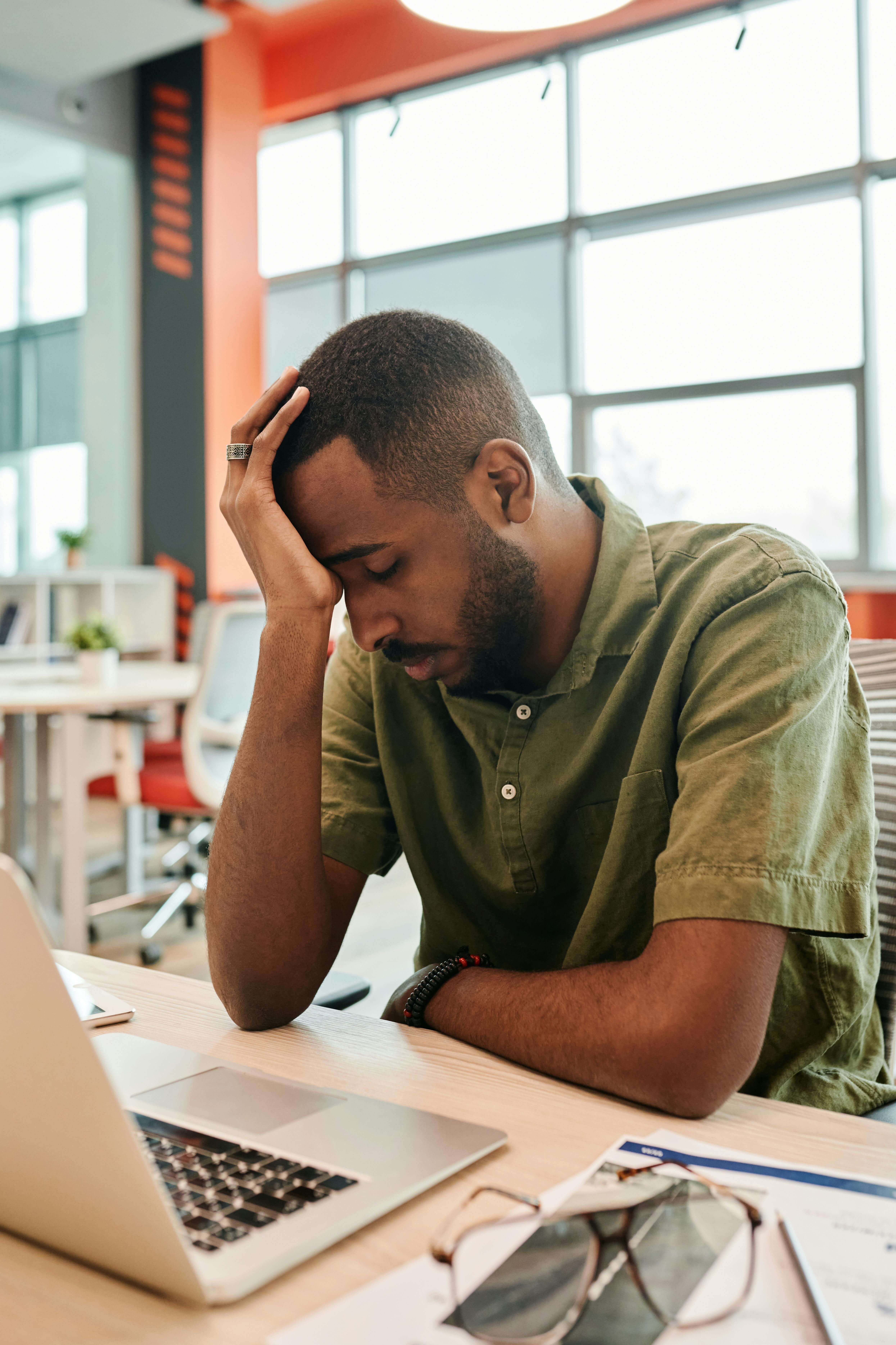 A man in a professional setting appears mentally exhausted, showing signs of burnout and emotional fatigue. This image reflects the need for depression treatment in Richmond, VA or Powhatan, VA with a skilled men’s counselor in Powhatan, VA. 