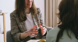 A compassionate counselor speaks with a client during a supportive session, reflecting the approach of an anxiety therapist in Richmond, VA who also provides narcissism therapy in Richmond, VA and online anxiety therapist services in Richmond, VA.