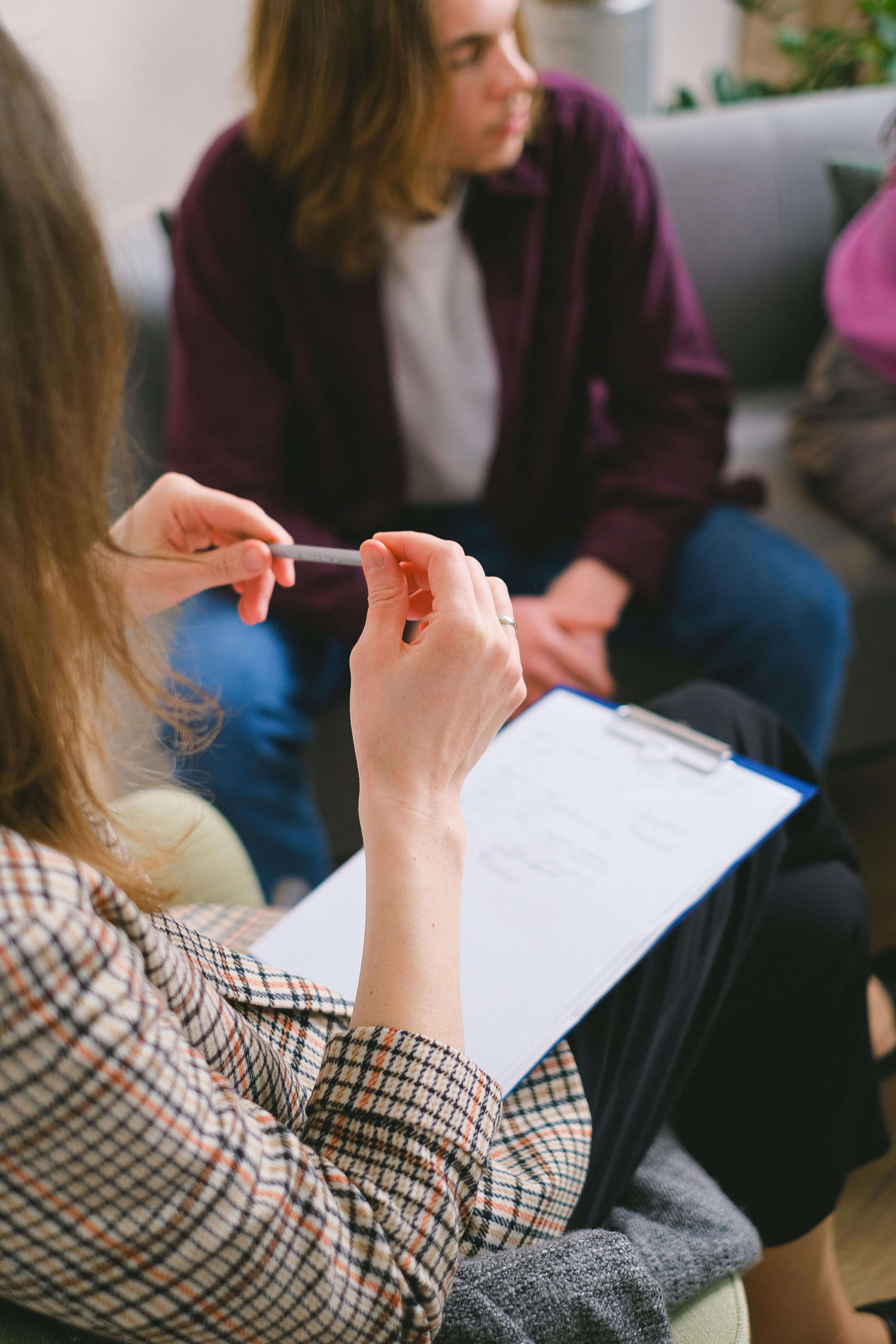 An EMDR therapist in Richmond, VA takes notes while guiding a client through processing work as part of EMDR intensives in Virginia and EMDR in Richmond, VA. 