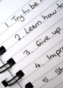 Close-up of a notebook page listing goals like “Try to be…” and “Learn how to…,” showing the pressure of resolutions and self-improvement. Helpful visual for depression treatment in goochland, va, connecting with an online depression therapist in goochland, va, or an online therapist in powhatan, va. 