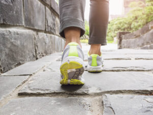A close-up of someone's feet mid-stride on a stone path, moving forward with purpose and momentum. It's a fitting image for the healing journey that trauma therapy in Richmond, VA and life transitions therapy in Charlottesville, VA can help make possible — one step at a time toward a life no longer defined by the past. 