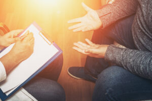 A therapist takes notes during an intensive therapy session in Richmond, VA, offering focused EMDR intensives in Virginia for trauma and PTSD recovery 