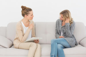 An EMDR therapist in Richmond, VA listens attentively to a client during an intensive EMDR therapy session in Richmond, helping her process trauma and find relief 