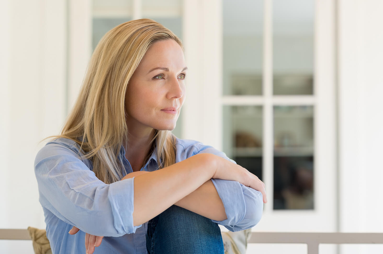 Woman reflecting quietly at home, representing the growth clients find through life transitions therapy in Fredericksburg, VA, life transitions therapy in Virginia, and support from an EMDR therapist in Powhatan, VA.